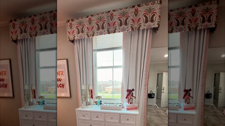 A custom DIY window treatment is shown in a light-filled pink room