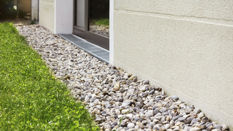 Gravel next to home with grass on the other side