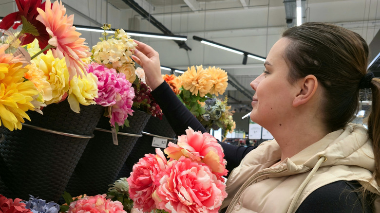 A person shopping for artificial flower stems