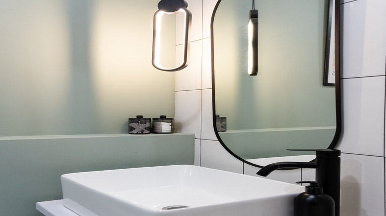 modern pendant light in front of a bathroom mirror