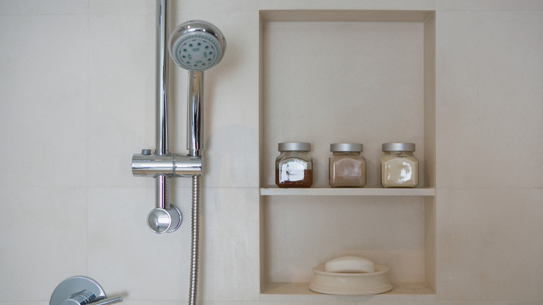 tan shower with built in shelving and silver hardware