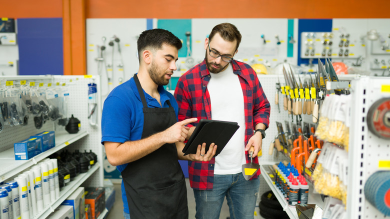 A person talks to a customer in a hardware store