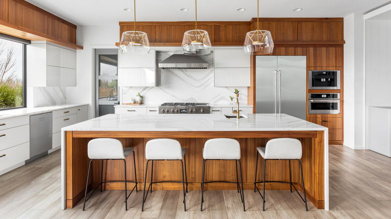 Modern wood kitchen with waterfall kitchen island countertop