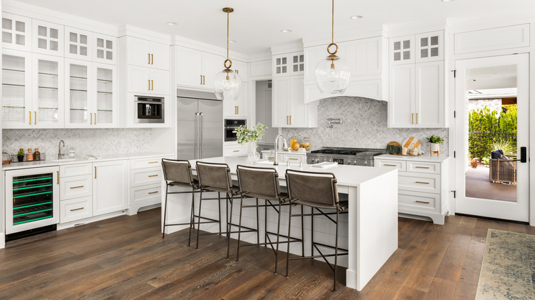 Modern white kitchen with waterfall island countertop
