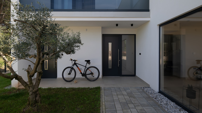 A modern home with a concrete and paver walkway