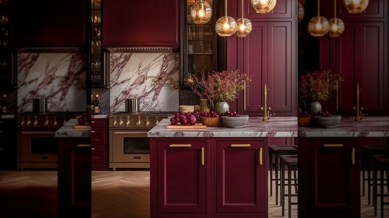 A luxury kitchen features burgundy cabinetry and dark veined marble countertops