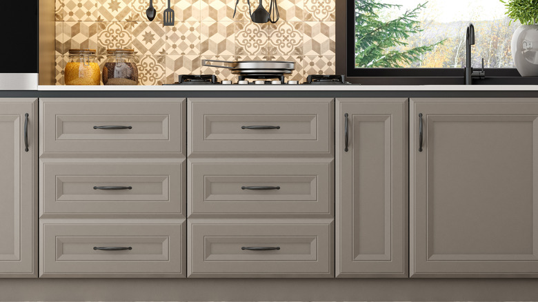 Kitchen cabinets are painted a mushroom taupe color