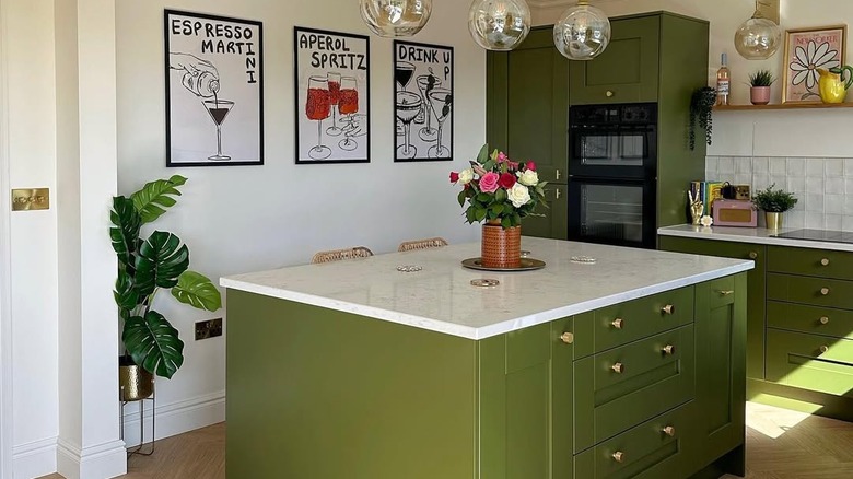 Cabinets in a modern kitchen are painted olive green.
