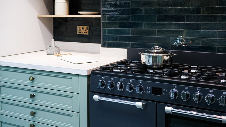 contemporary kitchen with dark blue kitchen backsplash