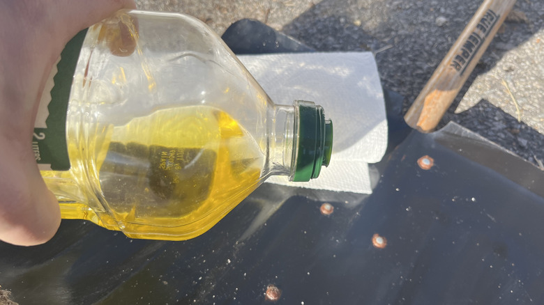 Applying olive oil to shovel