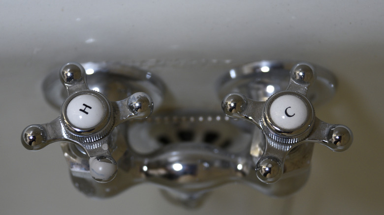 Hot and cold water taps on a vintage sink