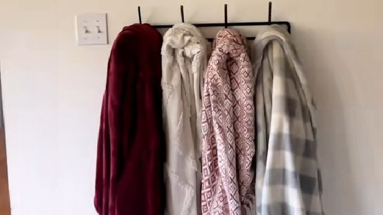 Blankets hung on a coat rack as a space-saving solution