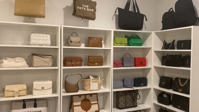 White bookshelves with purses organized and displayed individually sorted by color