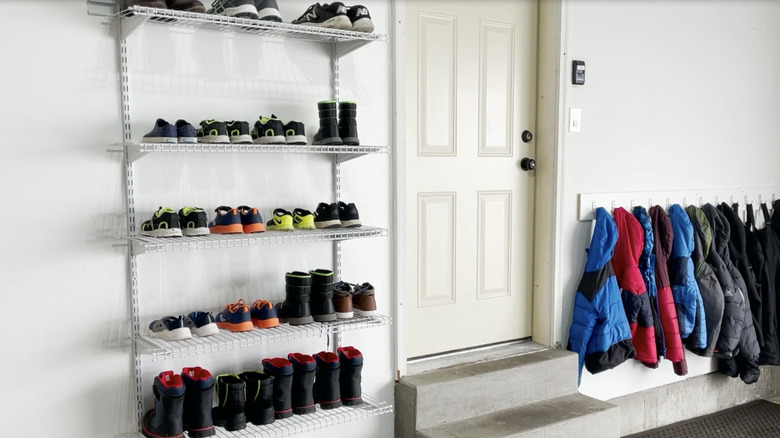 Garage wall with wire shelves with shoes on them