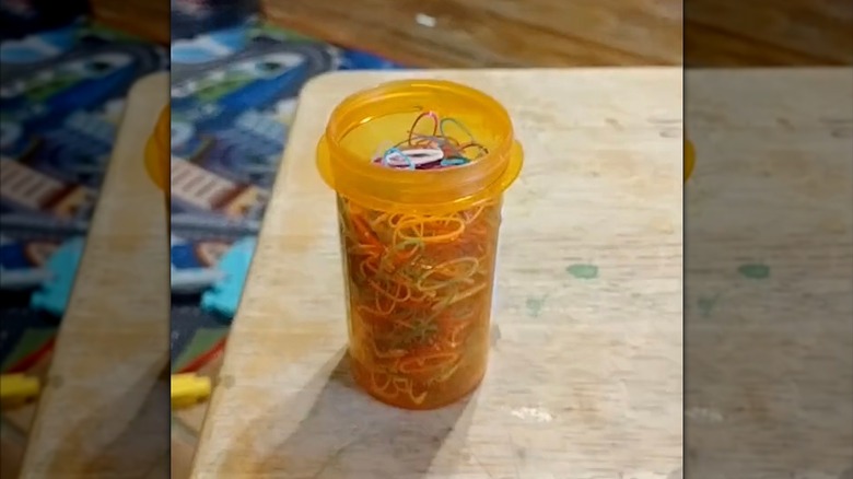 Old prescription bottle full of tiny hair rubberbands