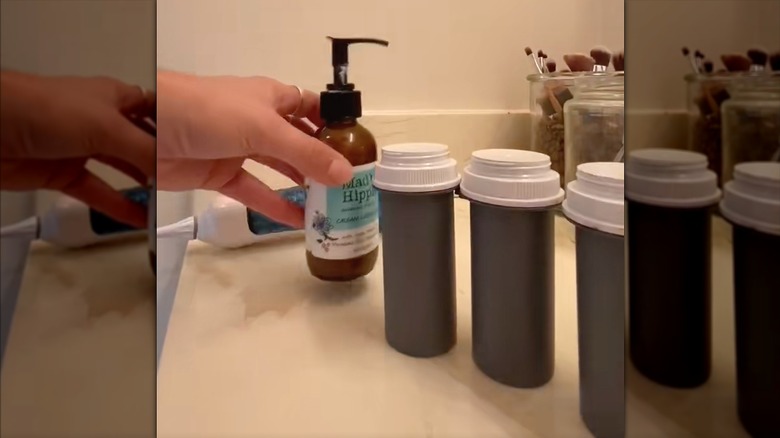 Gray-painted prescription canisters filled with lotion for travel
