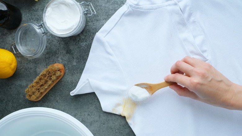 a person uses lemon juice and salt to clean a stain