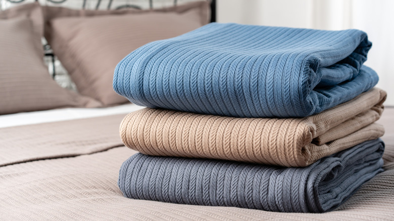 folded blankets on a bed