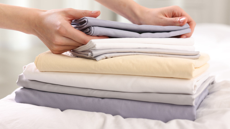 Person with stack of folded linens