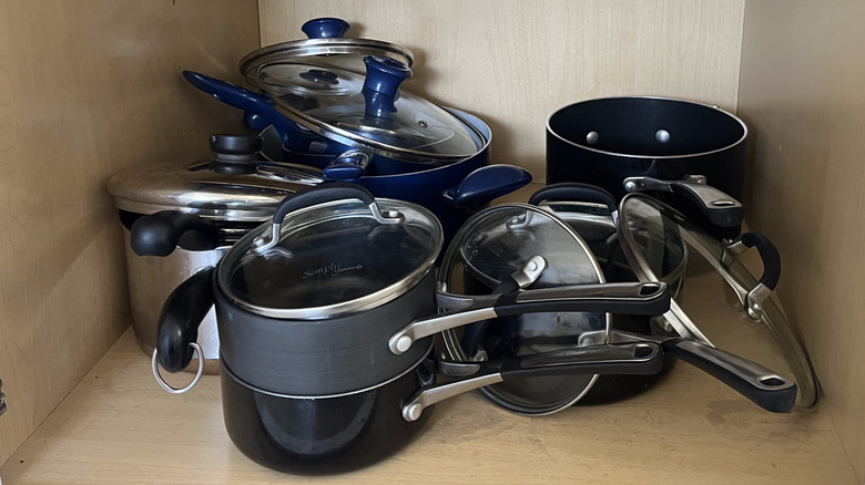 A mess of pots, pans, and pot lids