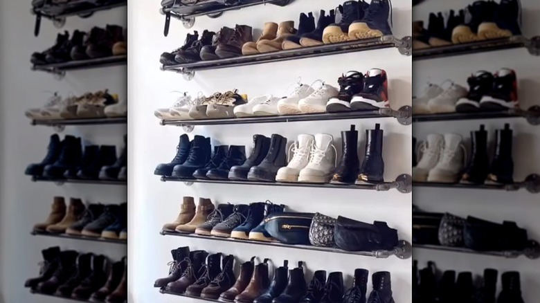 Shoes on shelves made from industrial black pipe.