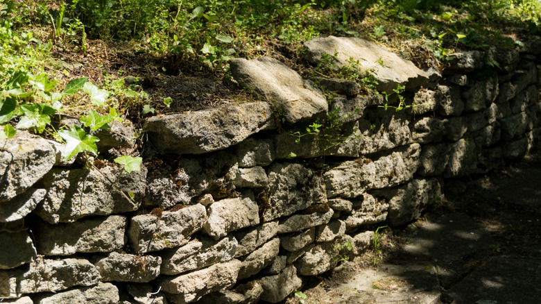 An old retaining wall built using large limestone blocks