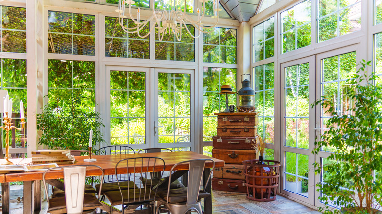 Traditional conservatory dining room with large glass windows