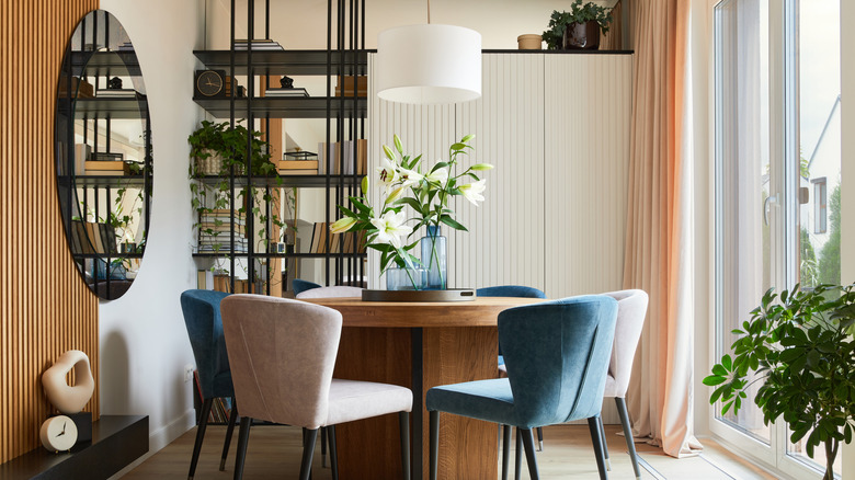 Casual contemporary dining room with curved elements near a patio door