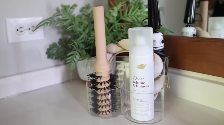 Hair tools are displayed on bathroom countertop in a Dollar Tree plastic organizer