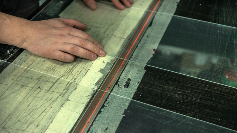 hands holding plexiglass