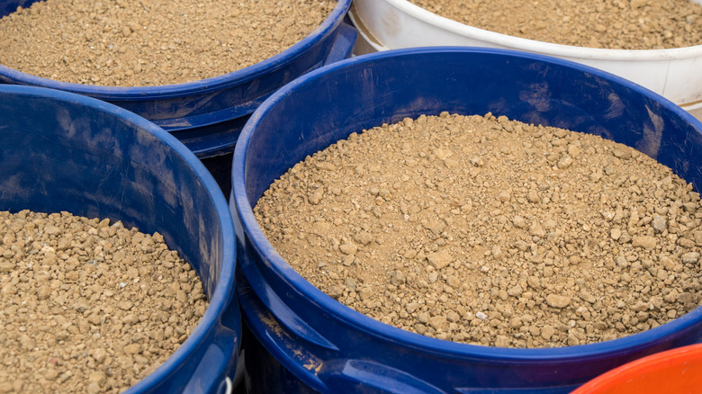Buckets of decomposed granite in various colors