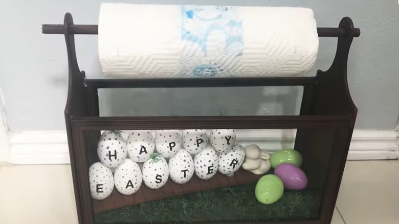 Paper towel holder with Easter decorations in the bottom display area