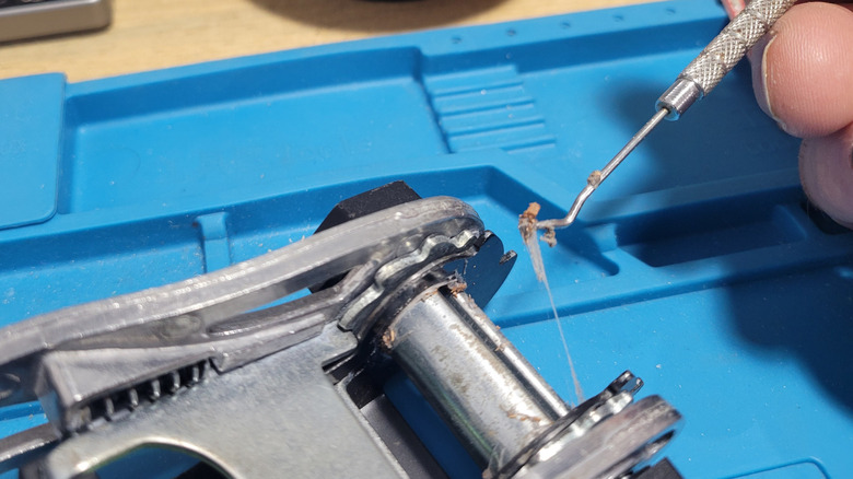 Removing butyl tape adhesive from ratchet straps used for testing