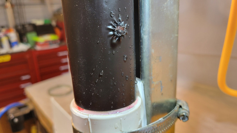 Water bursting through a 1/4-inch hole in a PVC pipe