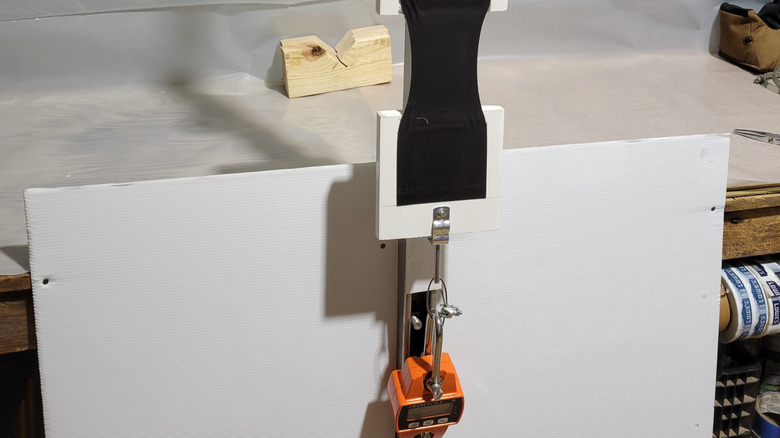 Scale and test rig used to evaluate tape adhesive strength