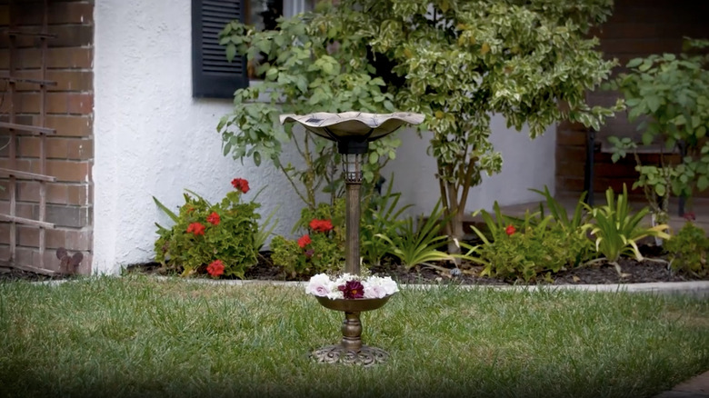 Best Choice's solar lighted birdbath sits in front of a flower bed
