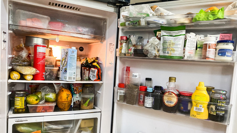 disorganized fridge full of food