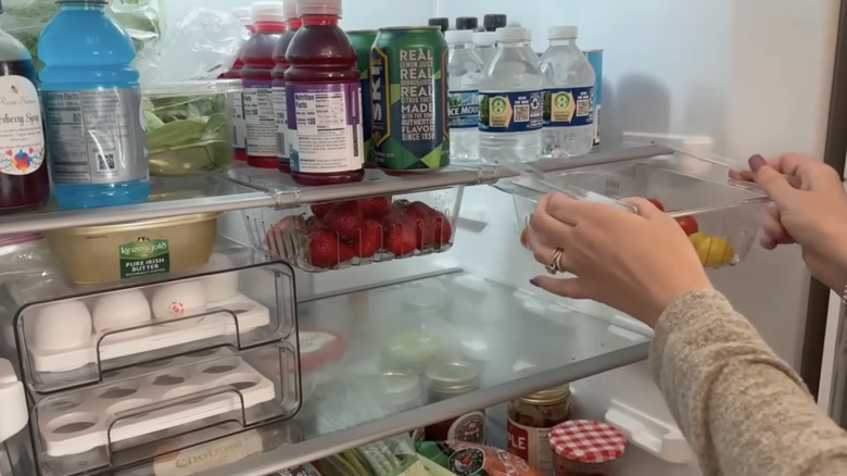 using a Dollar Tree clip on baskets on a fridge shelf to organize food