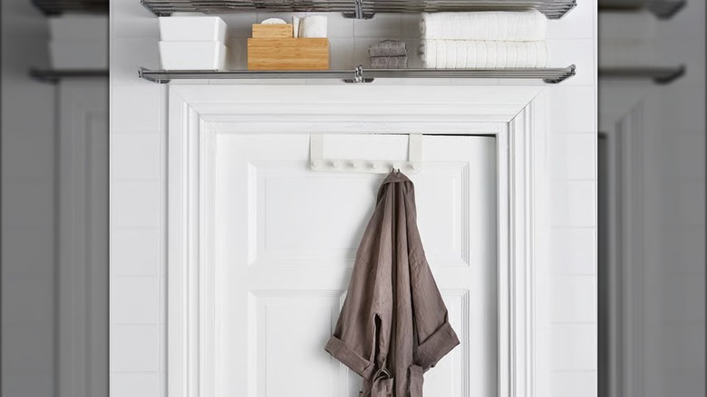 A brown bathrobe hangs from a white ENUDDEN over-the-door hanger