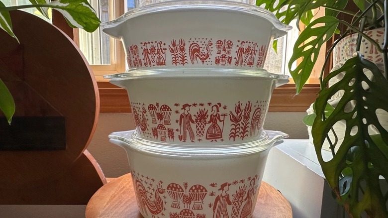 A set of three Pyrex Cinderella casserole dishes in the pink Butterprint pattern