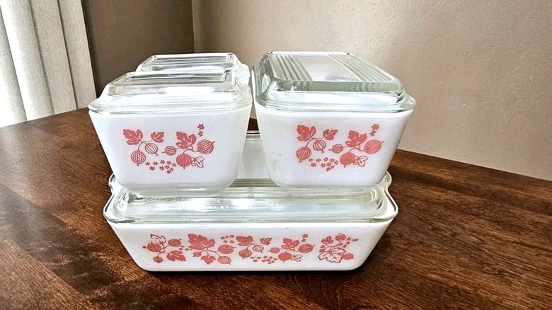 A set of four Pyrex refrigerator dishes in the pink Gooseberry pattern