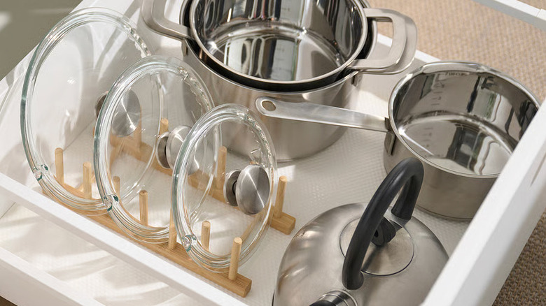 Glass lids on an IKA OSTBIT plate holder next to several metal pans