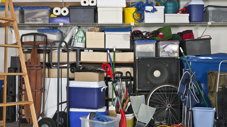 Overflowing garage shelves with random boxes and tools