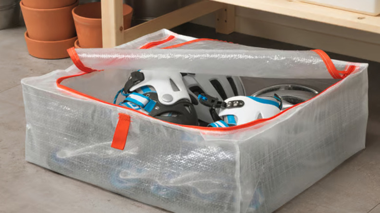 PÄRKLA organizer on a garage floor with roller skates in it.