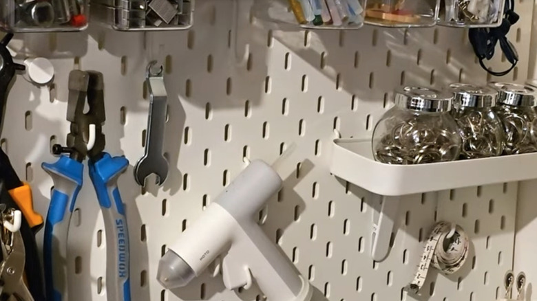 IKEA pegboard with tools and craft items on it.