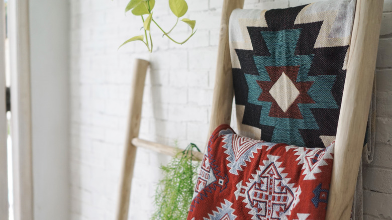 blankets folded on a blanket ladder