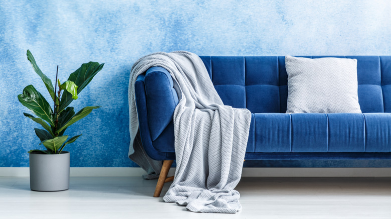 a blanket draped over a blue couch