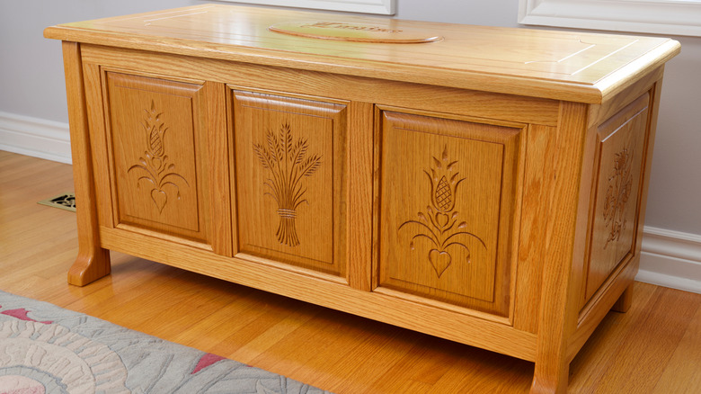 a large cedar chest decorated with etchings of plants