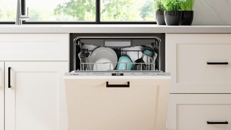 Bosch panel ready dishwasher open in modern white kitchen