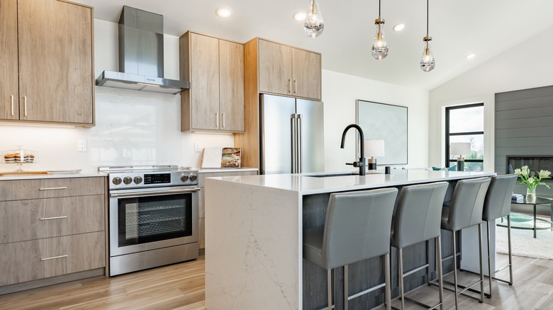 modern kitchen with wood cabinets and stainless steel appliances